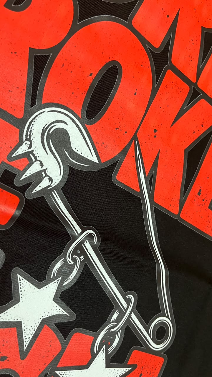 Red and white graphic print detail on a black tee